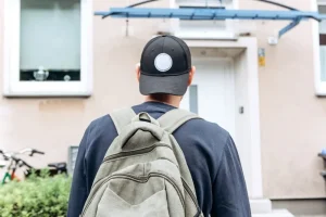 ゲストハウスの前に立っている外国人男性の後ろ姿